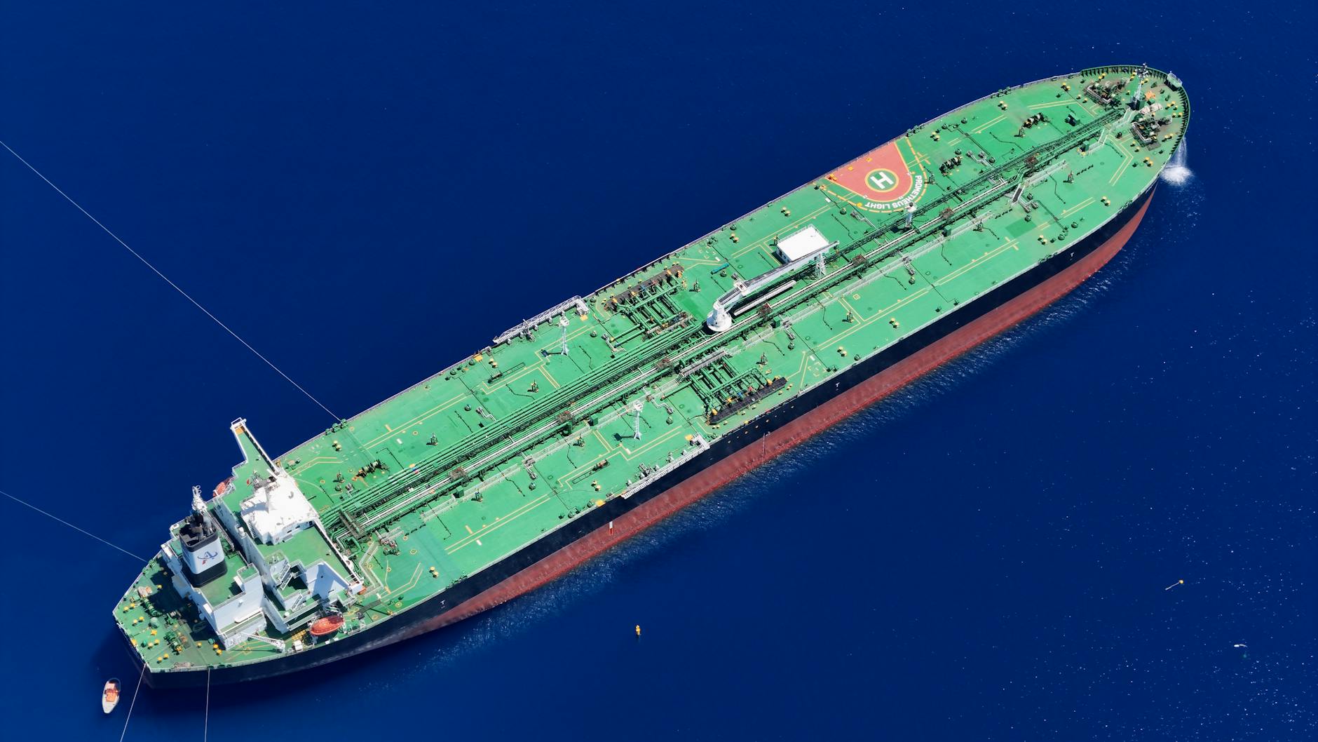 Iran blockade Trump deal Large oil tanker ship sailing on open sea with cargo barrels representing global oil trade and blockade